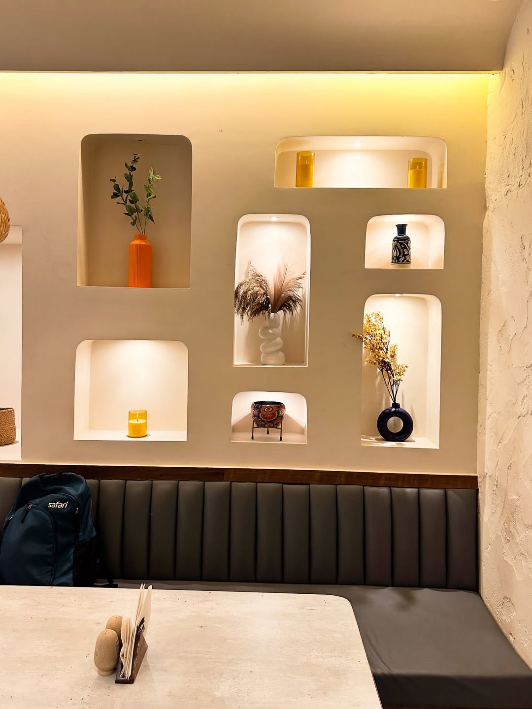 Decorative wall niches above the banquette
